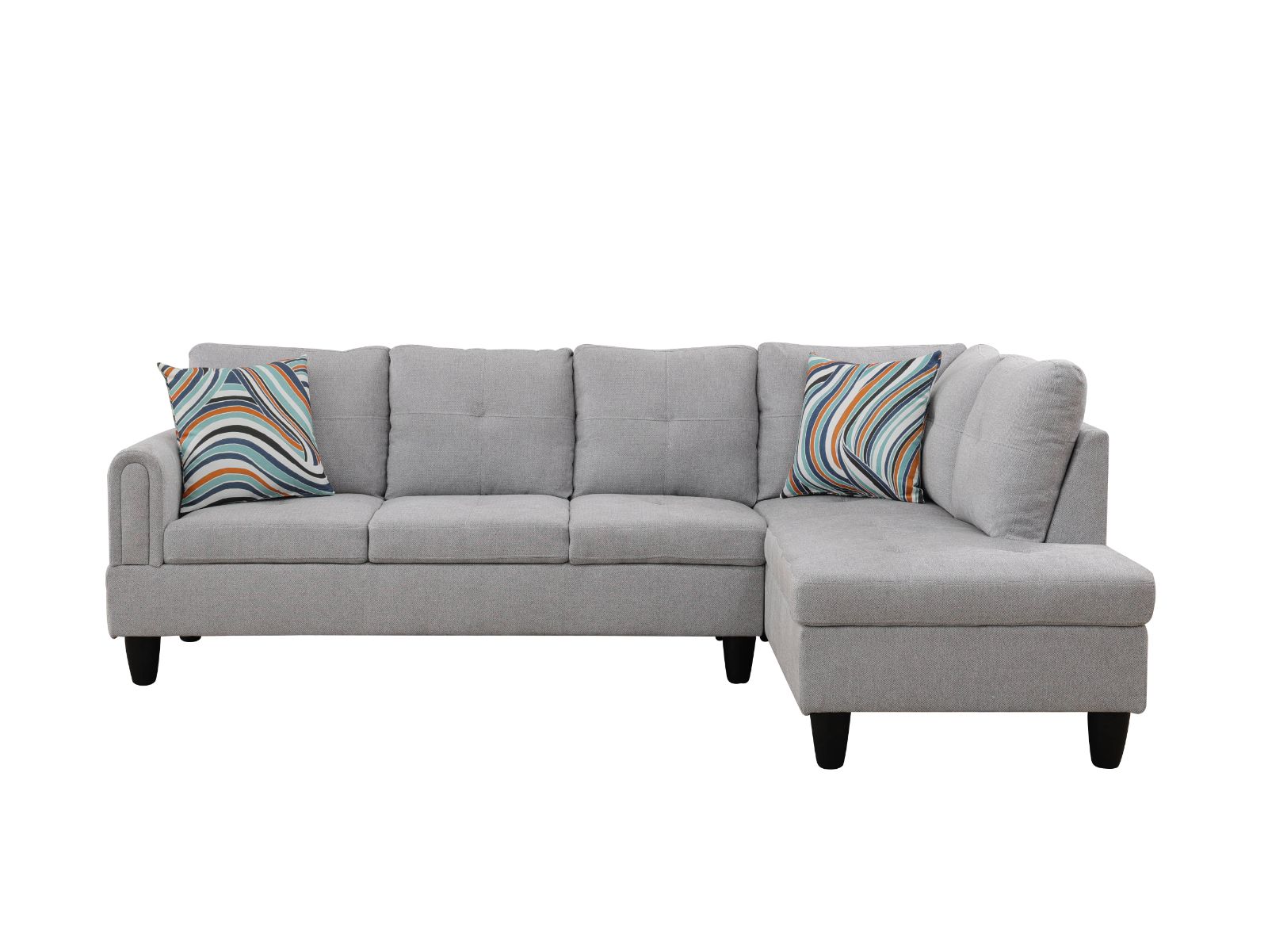Grey fabric sectional sofa with tufted cushions and colorful throw pillows