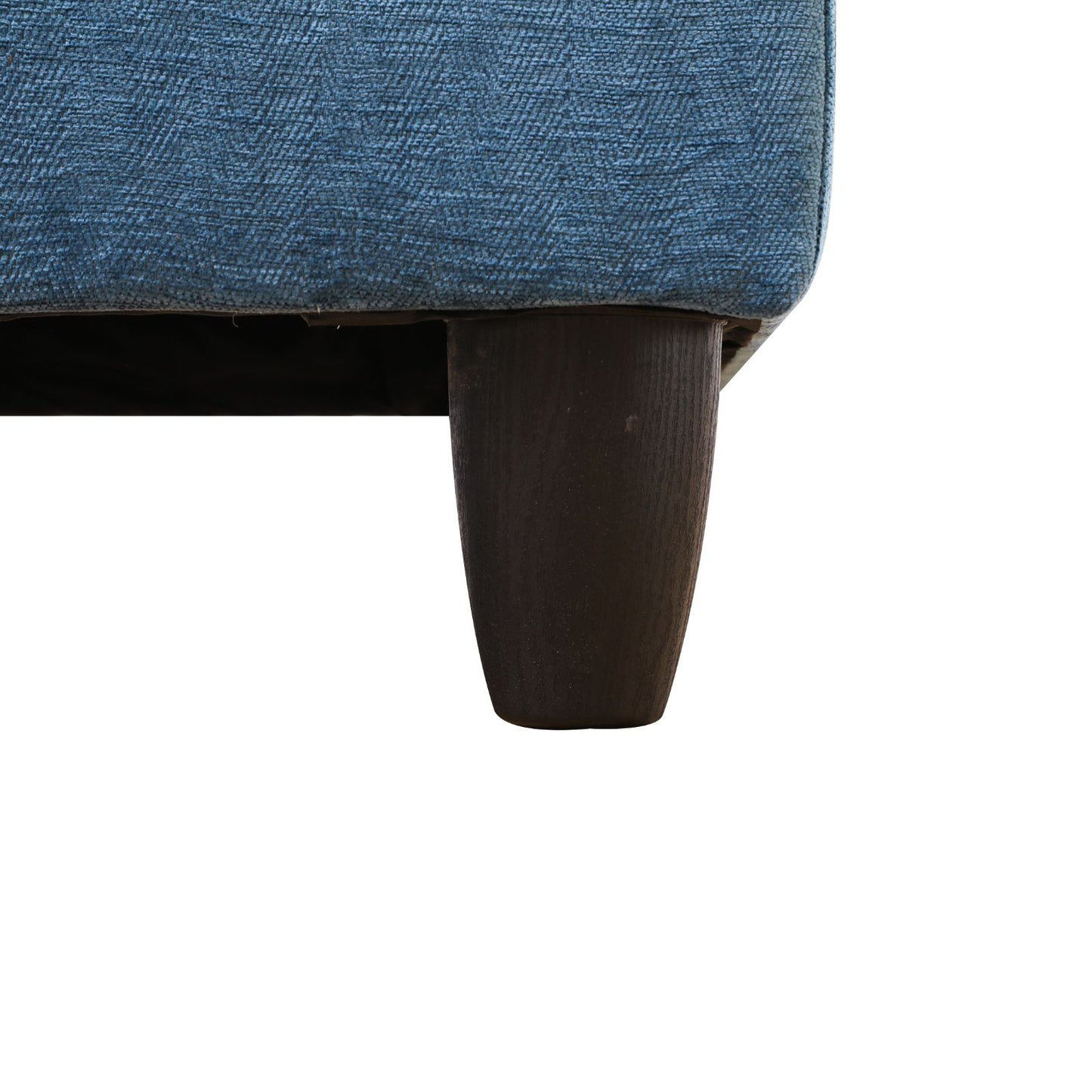 Blue fabric sofa leg detail with dark wood tapered foot