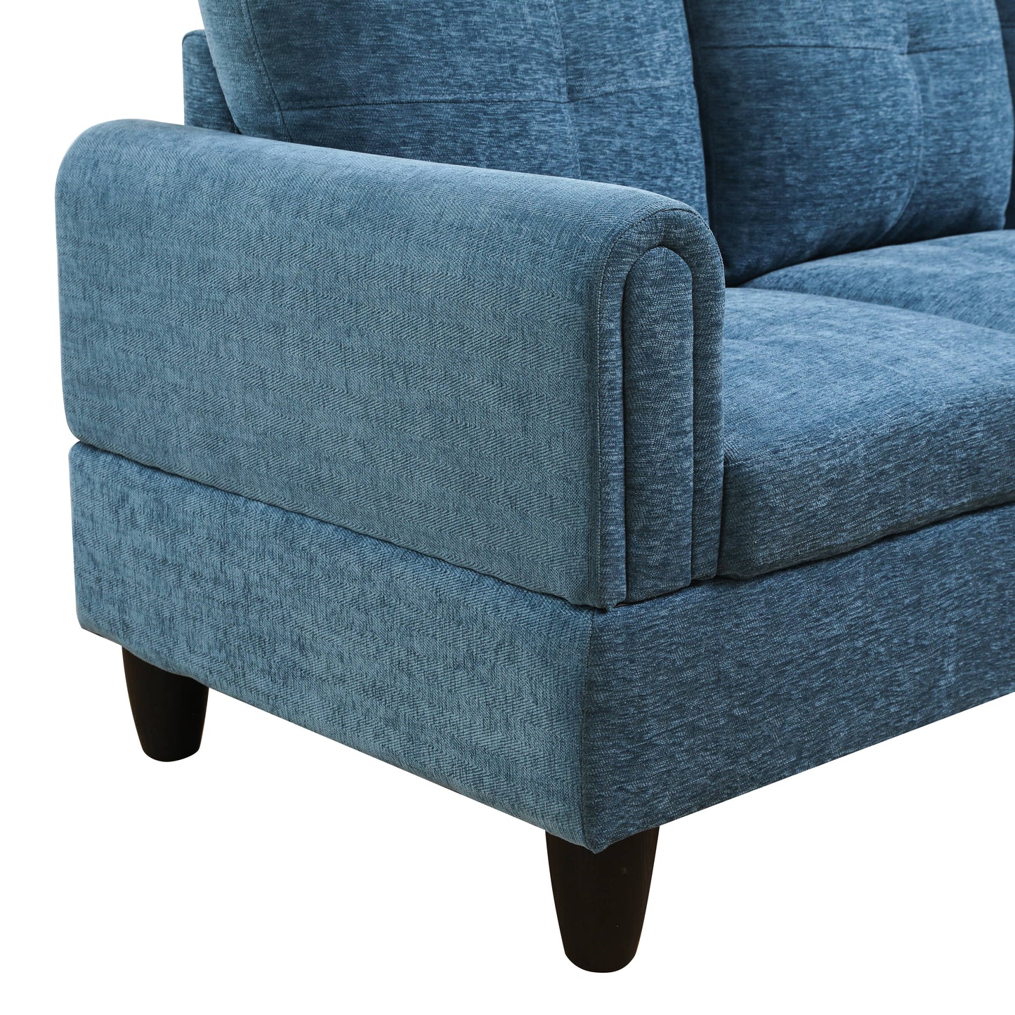 Closeup of a plush blue fabric sofa armrest with a textured weave