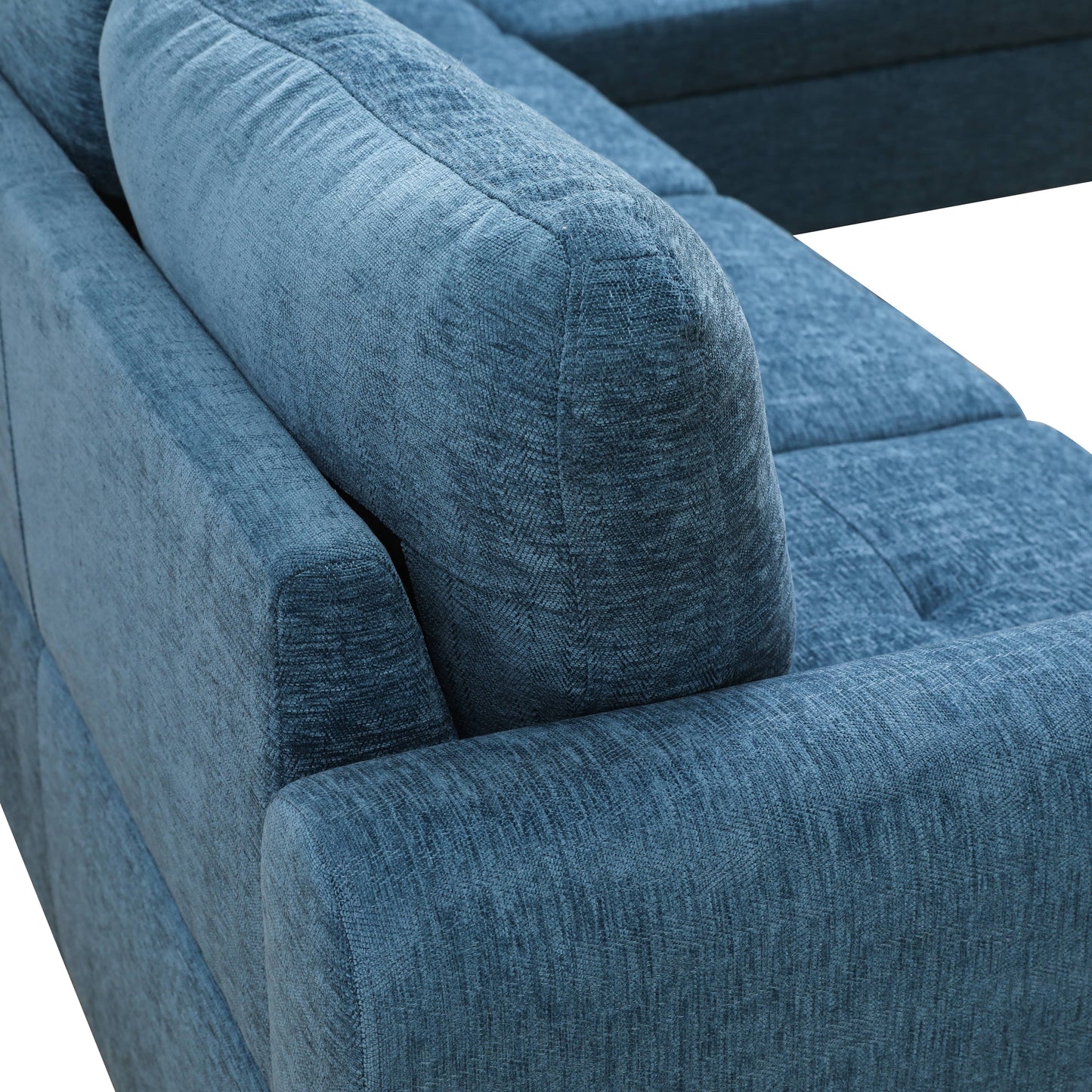 Closeup of textured blue fabric on a modern sectional sofa armrest