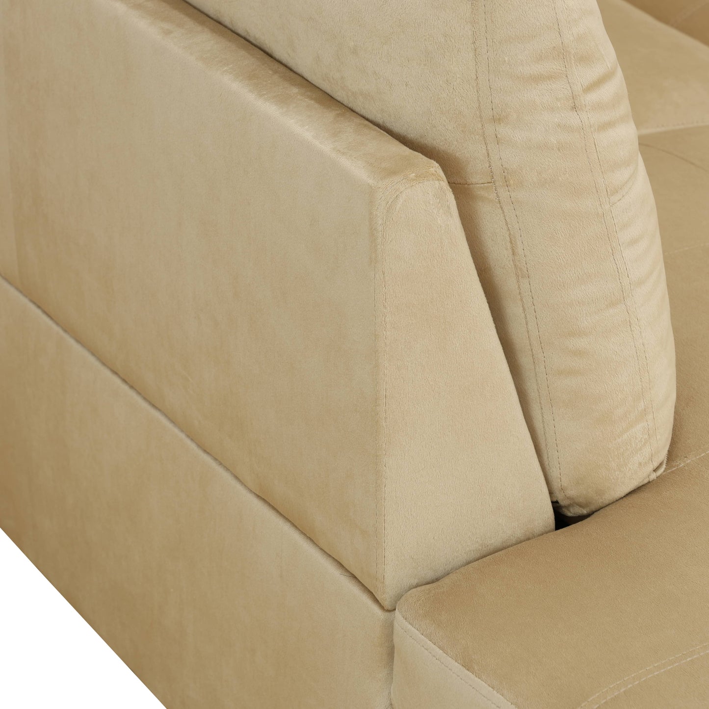 Closeup of beige velvet sofa armrest with plush texture and stitching detail