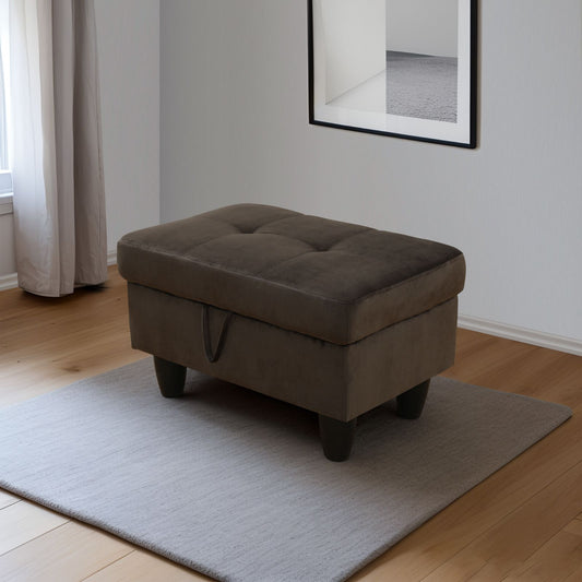 Dark brown tufted storage ottoman with dark wooden legs on a light grey rug