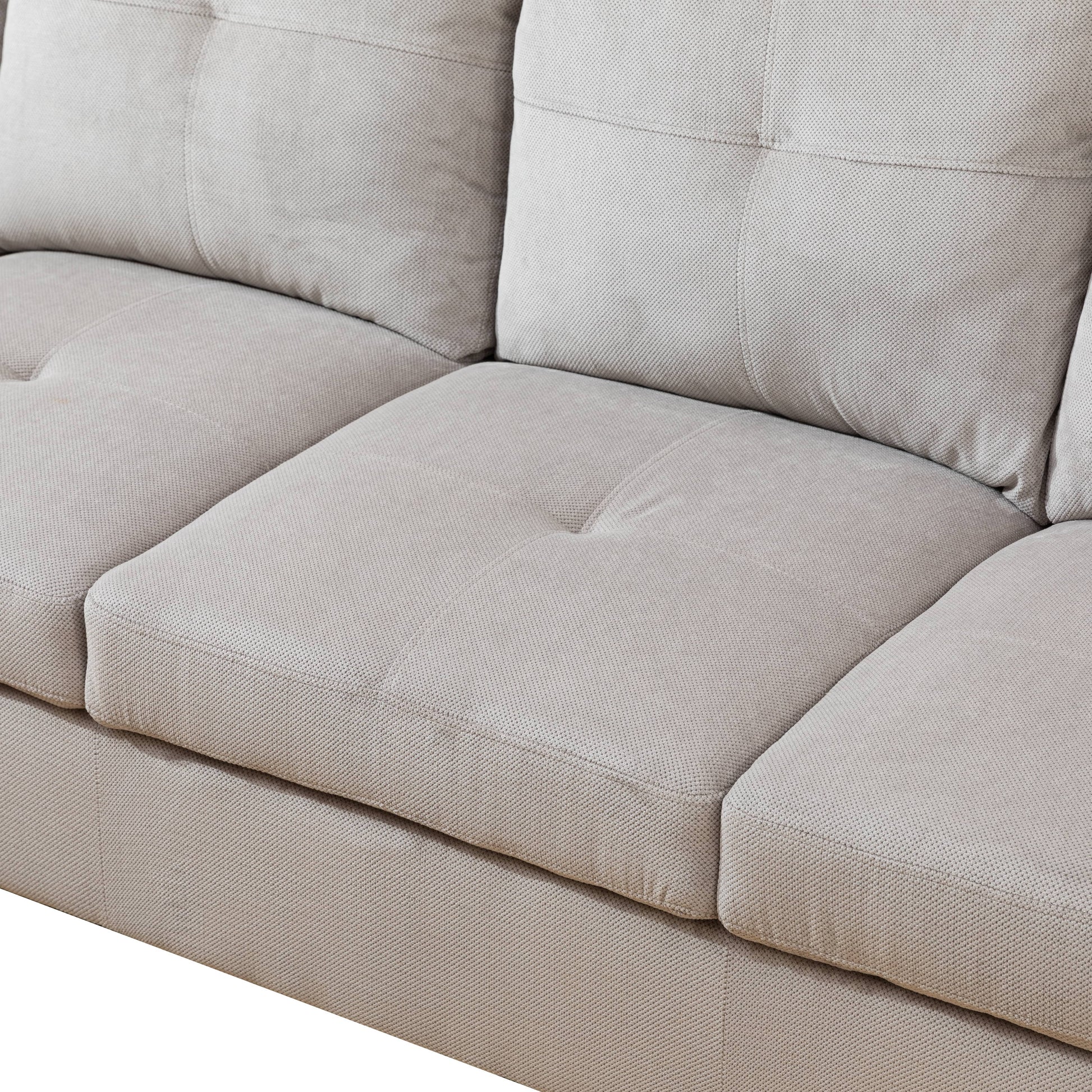 Light gray sectional sofa with textured fabric and deep seats