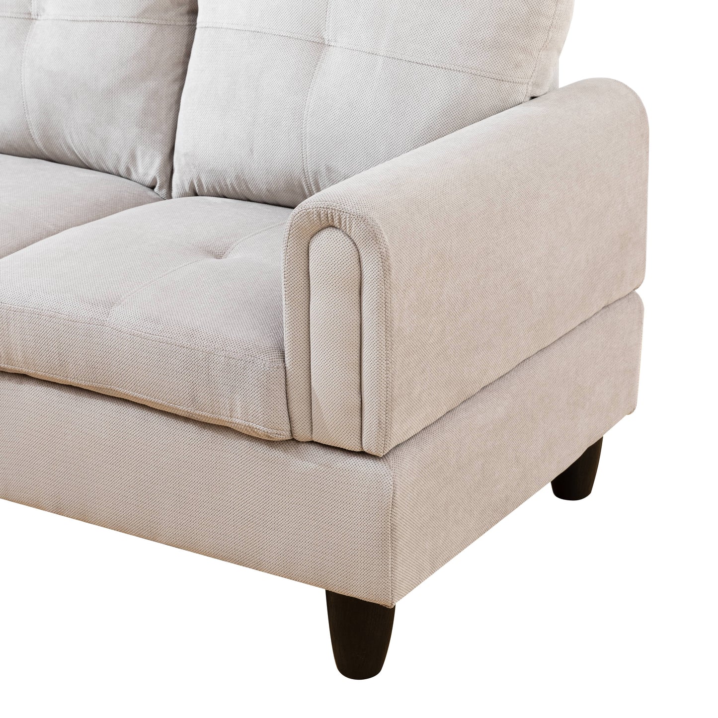 Light beige fabric sofa arm with tufted cushions and dark wooden legs