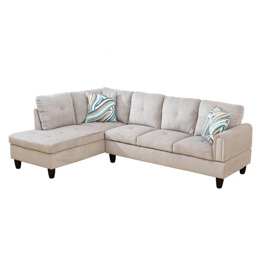 Light gray fabric sectional sofa with tufted chaise and decorative pillows