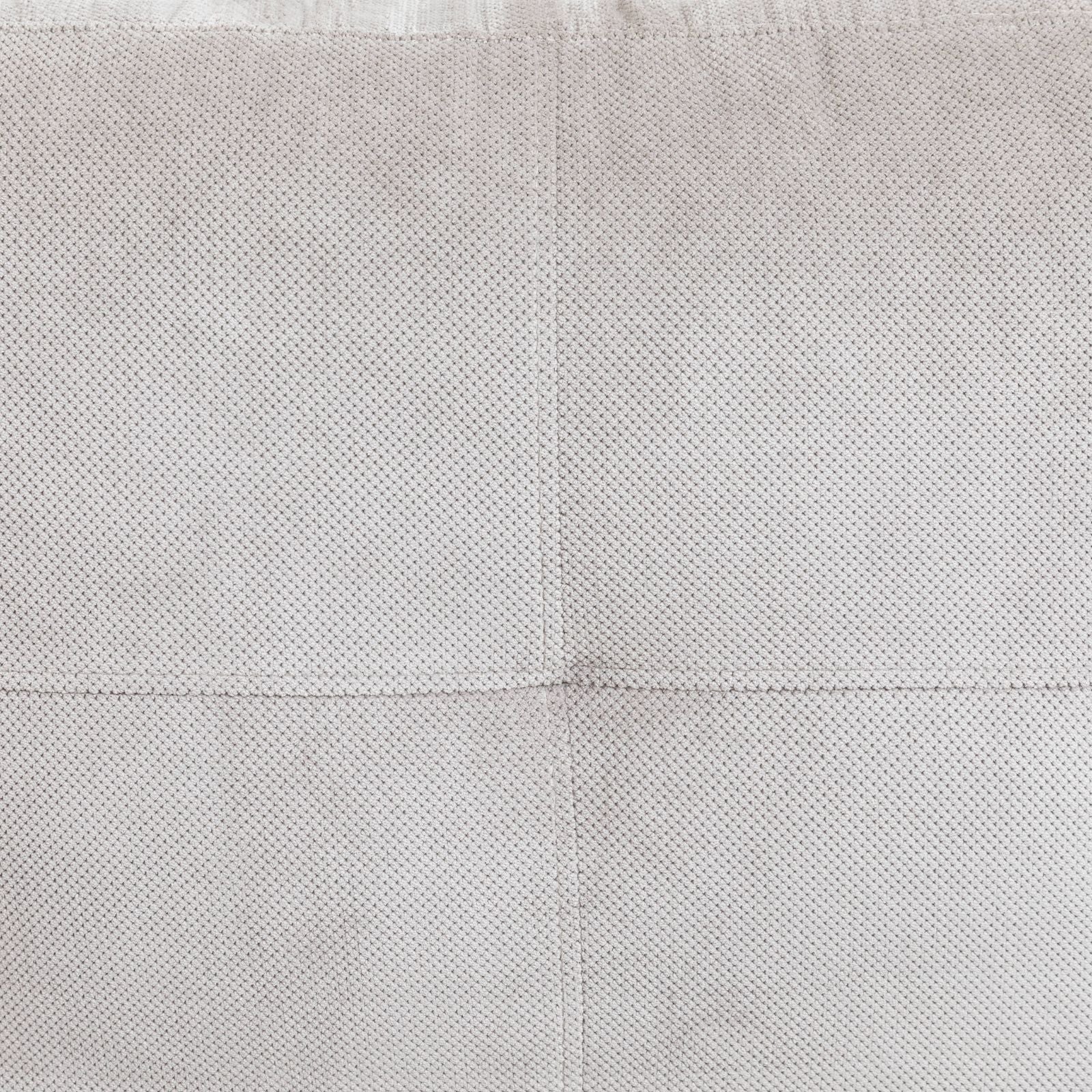 Light gray knitted throw blanket with a textured diamond pattern