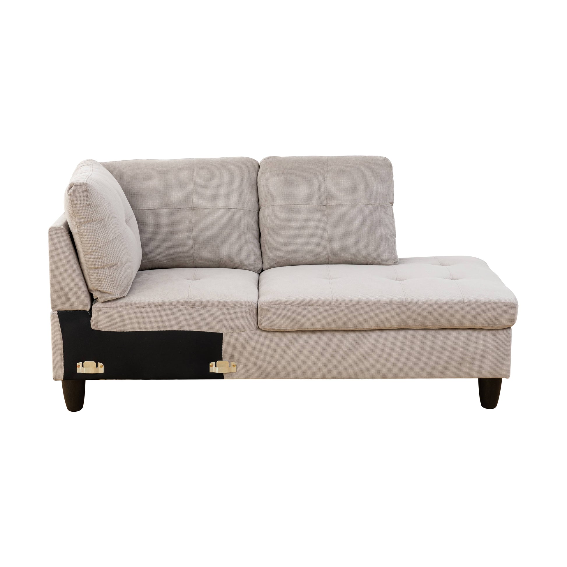 Light gray sectional couch with tufted seat cushions