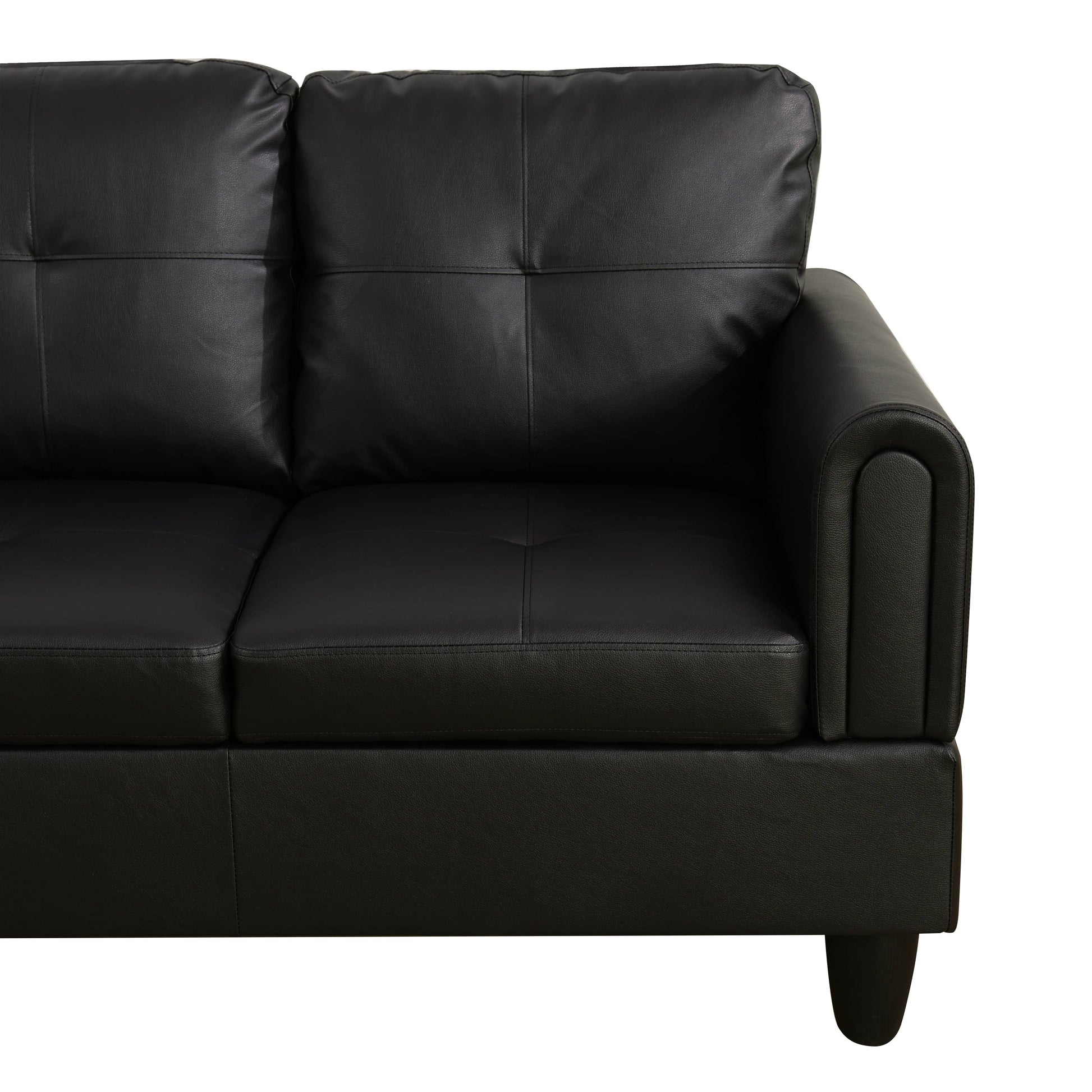 Black leather sofa with tufted cushions