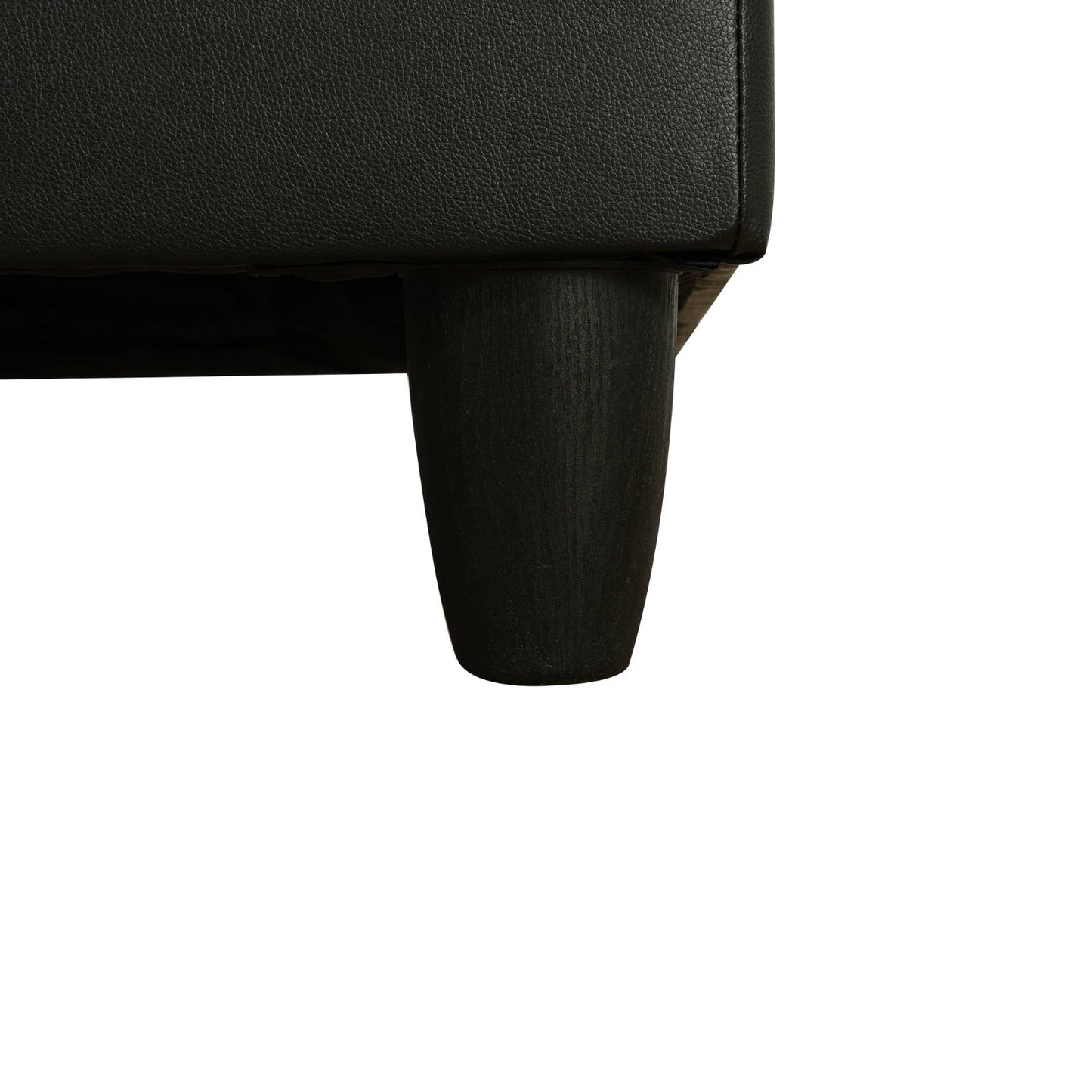 Black faux leather sectional sofa corner with dark wood tapered leg