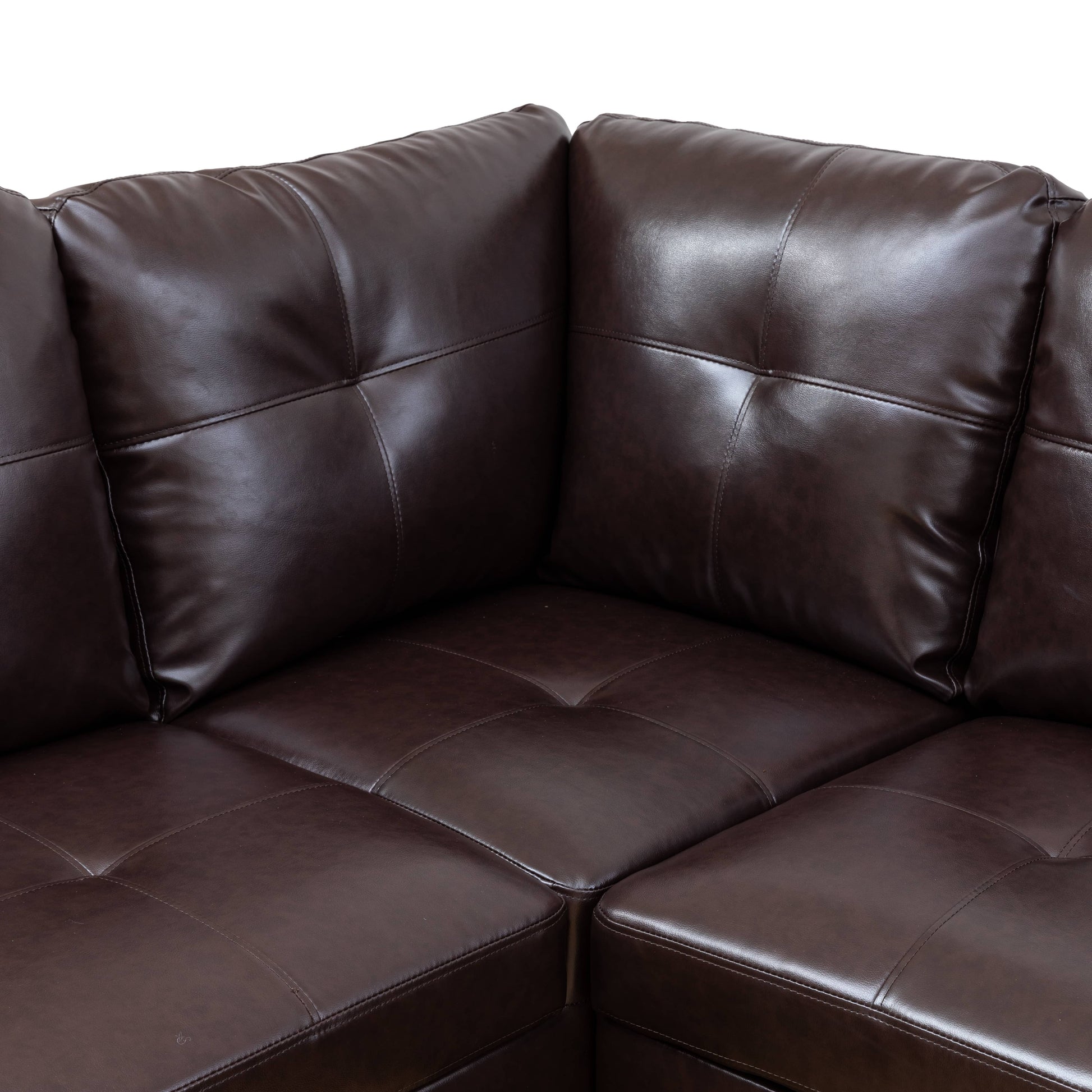Dark brown tufted leather sectional sofa corner detail