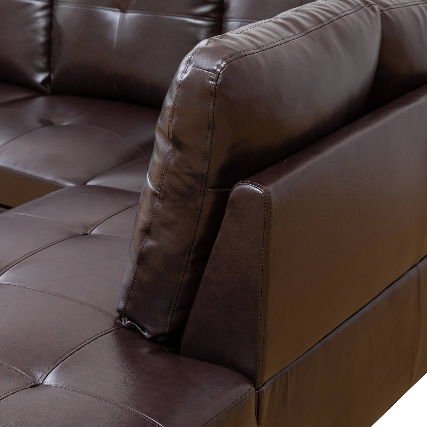 Brown faux leather sectional sofa with tufted cushions