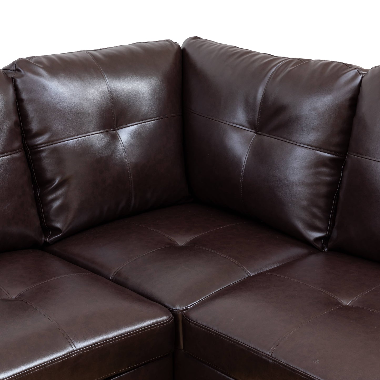 Dark brown tufted faux leather sectional sofa corner detail