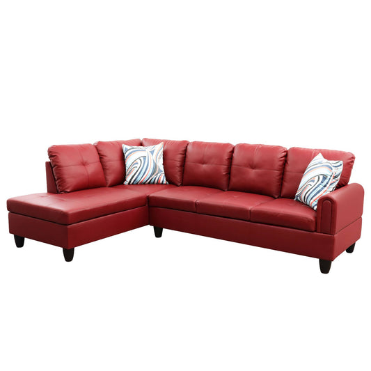 Red leather sectional sofa with tufted cushions and decorative pillows