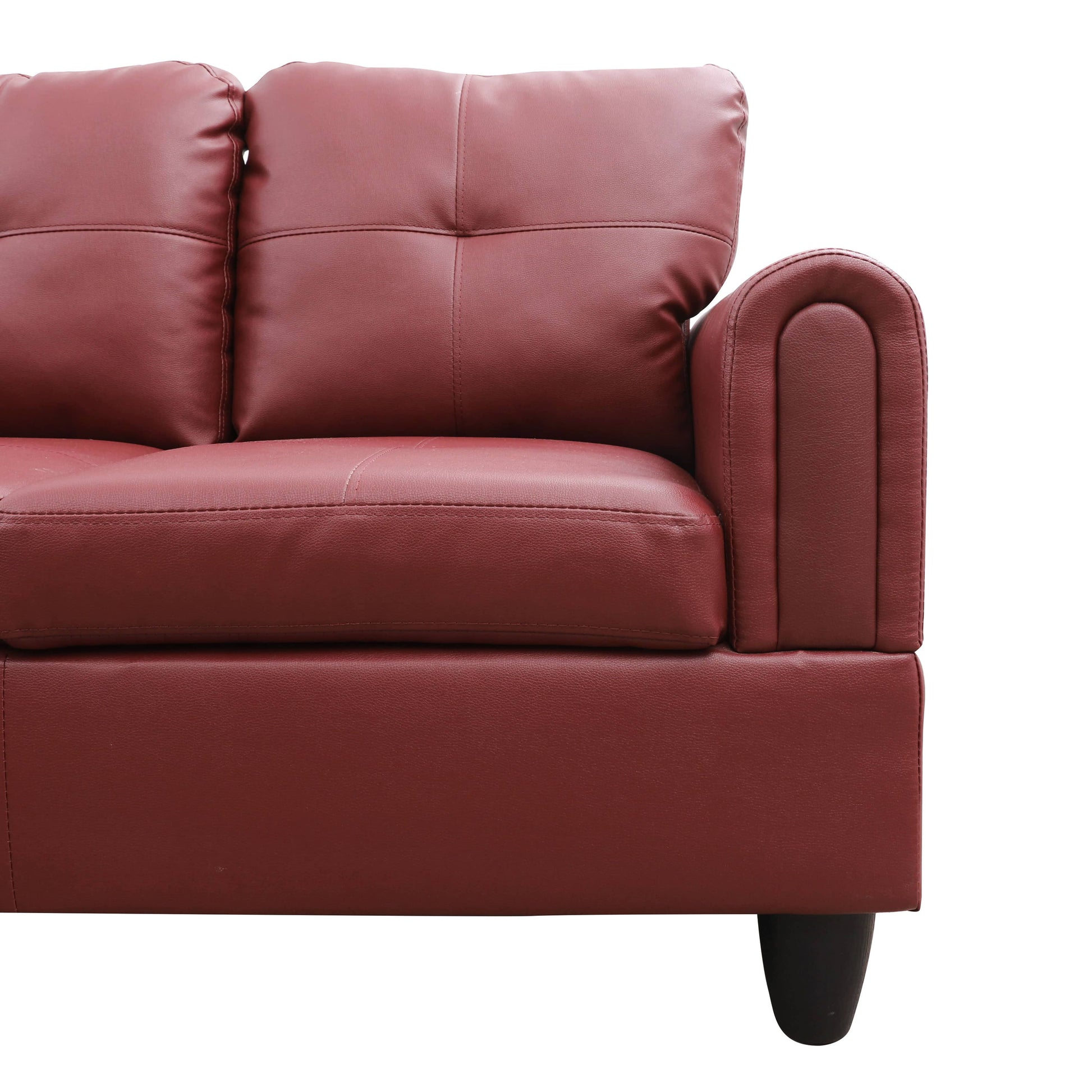 Maroon faux leather sofa with tufted back cushions and a rounded armrest