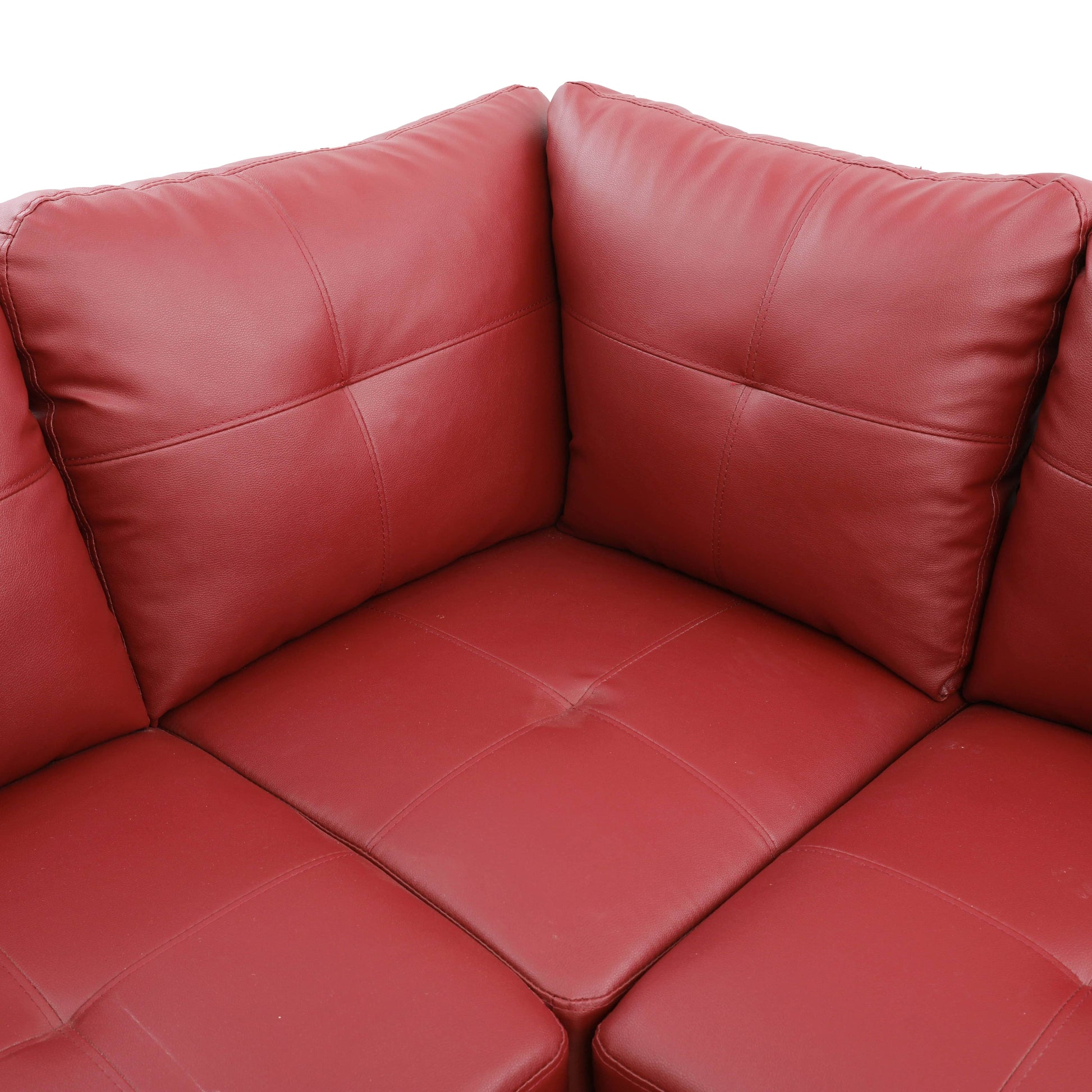 Red leather corner sectional sofa with tufted cushions and stitching