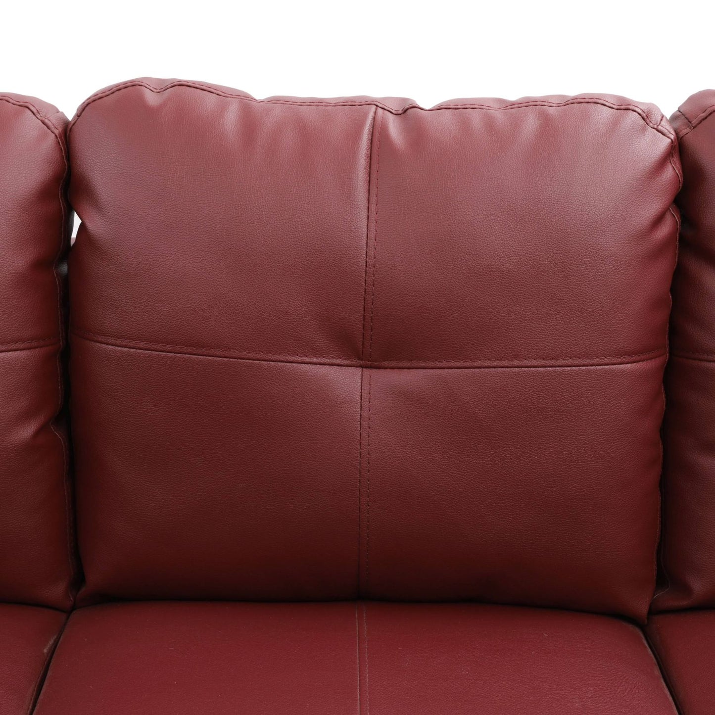 Closeup of quilted plush burgundy faux leather couch cushion detail