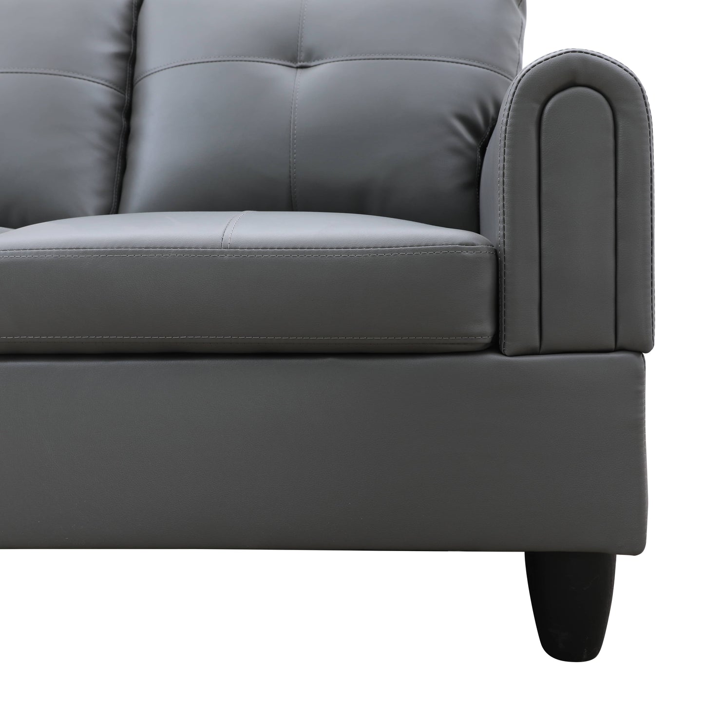 Gray faux leather sofa with tufted back cushions and rolled armrest