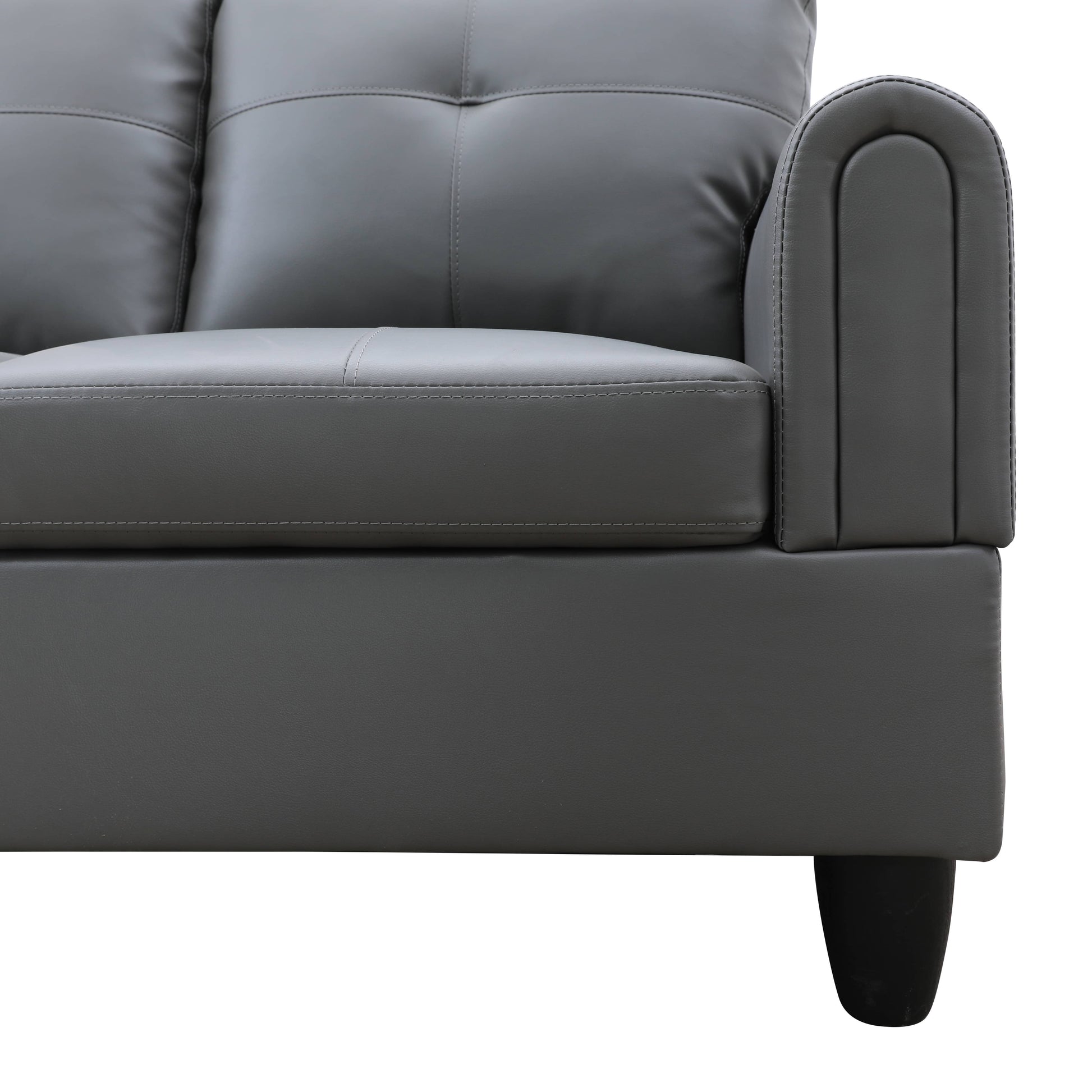 Gray faux leather sofa with tufted back cushions and rolled armrest
