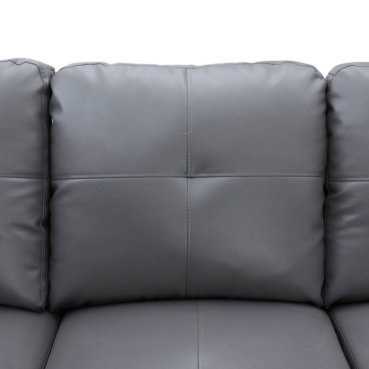 Closeup of gray faux leather sofa cushions with detailed stitching
