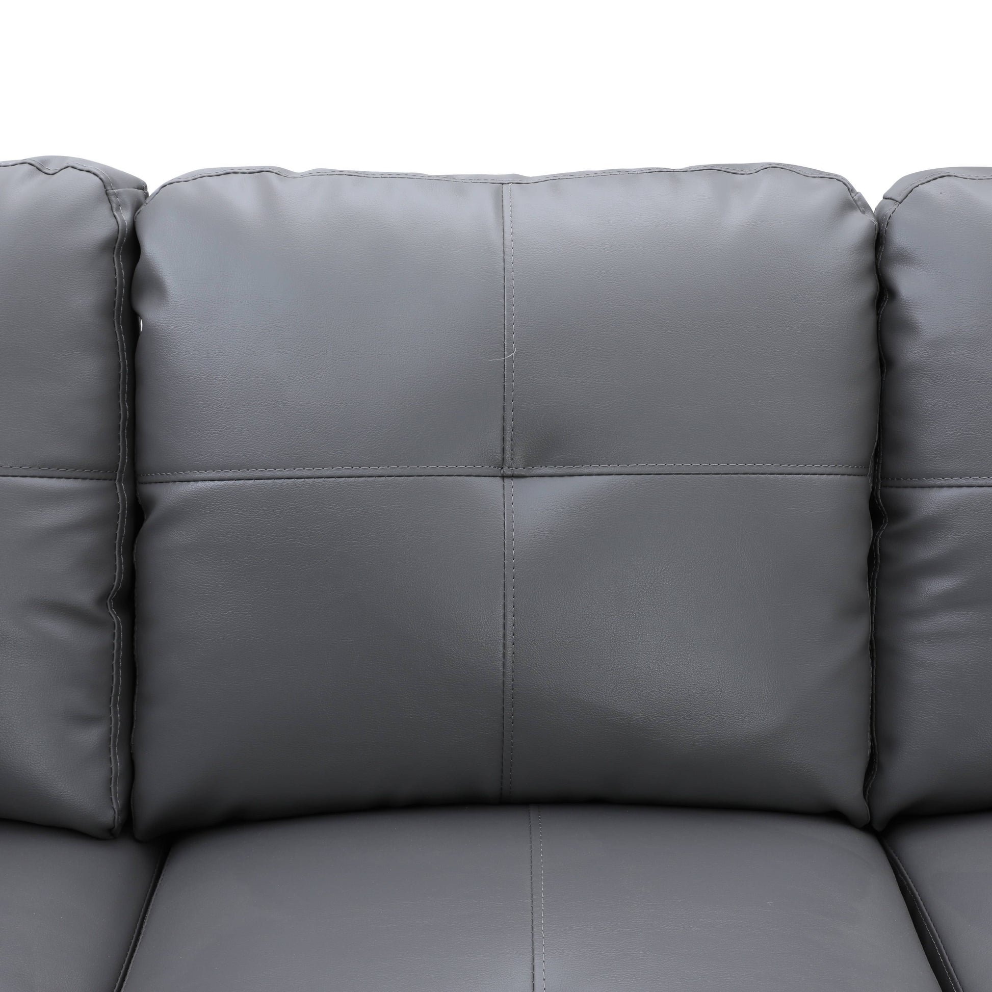 Closeup of gray faux leather sofa cushions with detailed stitching