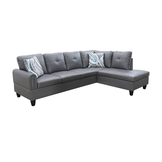 Gray faux leather Lshaped sectional sofa with tufted cushions and decorative pillows