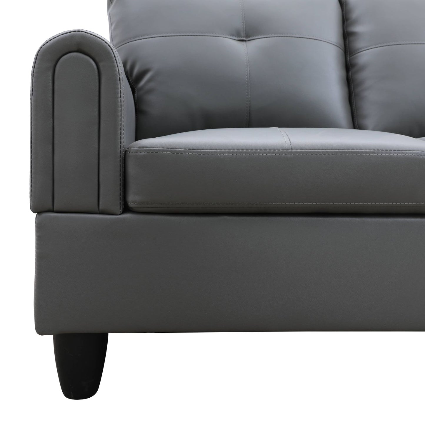 Gray faux leather sofa with tufted back cushions and arched armrest