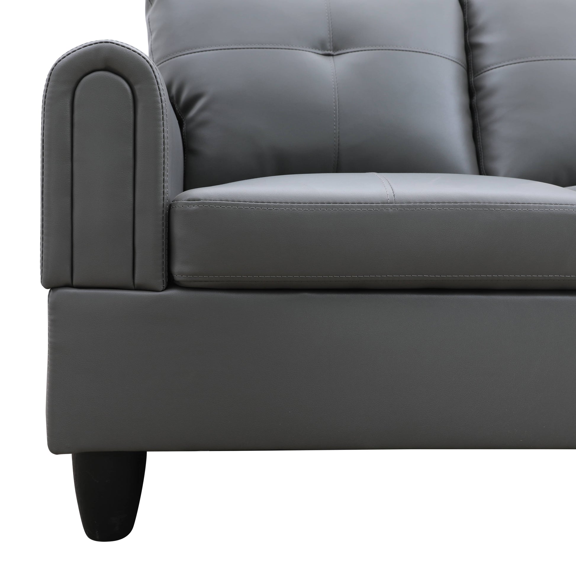 Closeup of a gray faux leather sofa armrest with detailed stitching