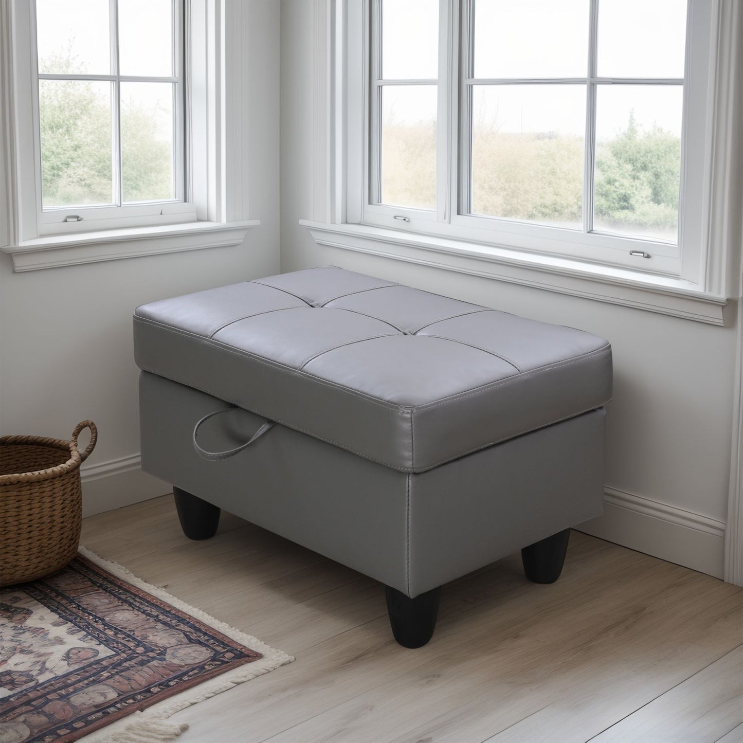 Tufted grey faux leather storage ottoman with attached handle