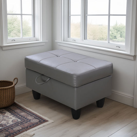 Tufted grey faux leather storage ottoman with attached handle