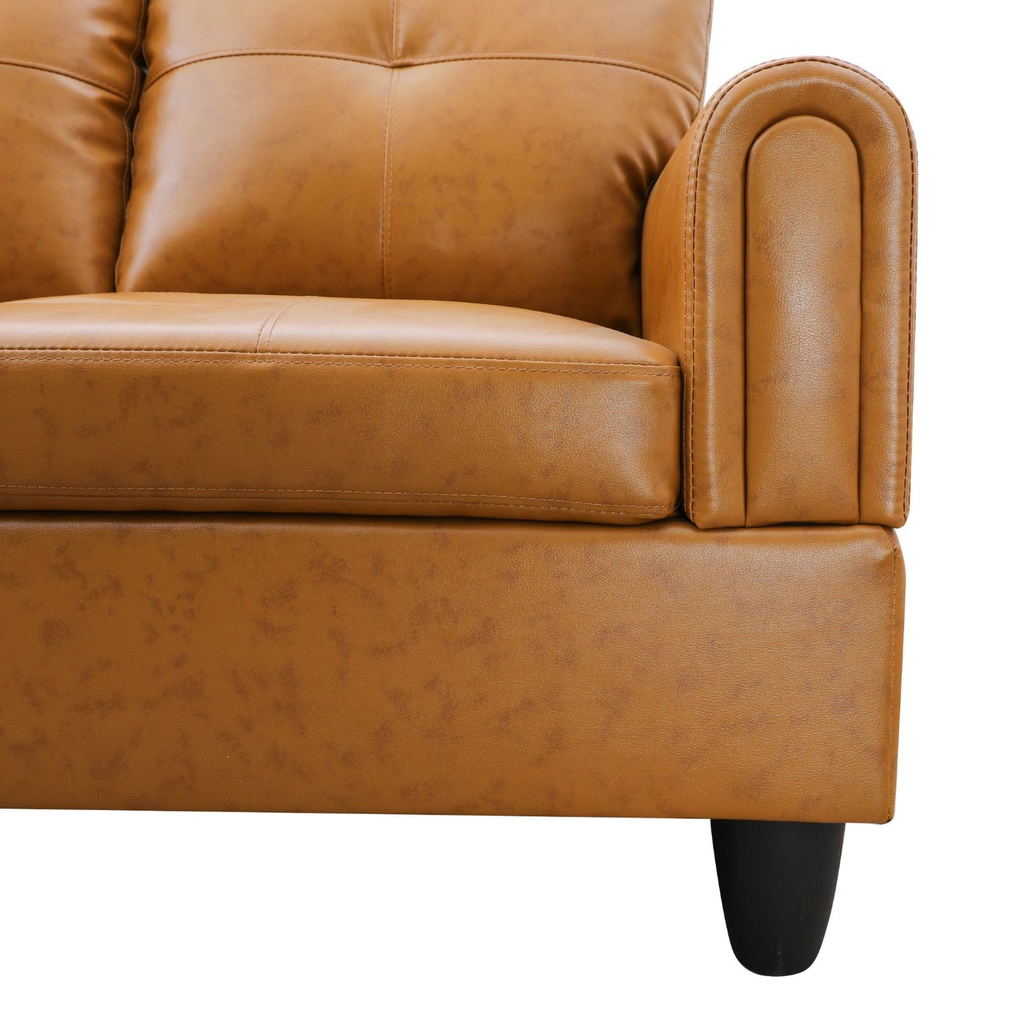 Tan faux leather sofa armrest with button tufted back cushion