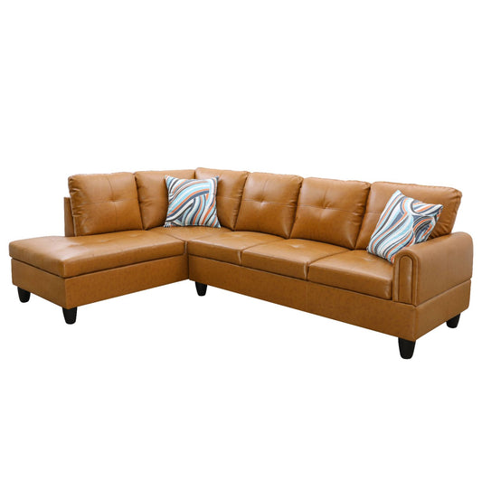 Tan leather sectional sofa with chaise lounge and decorative pillows