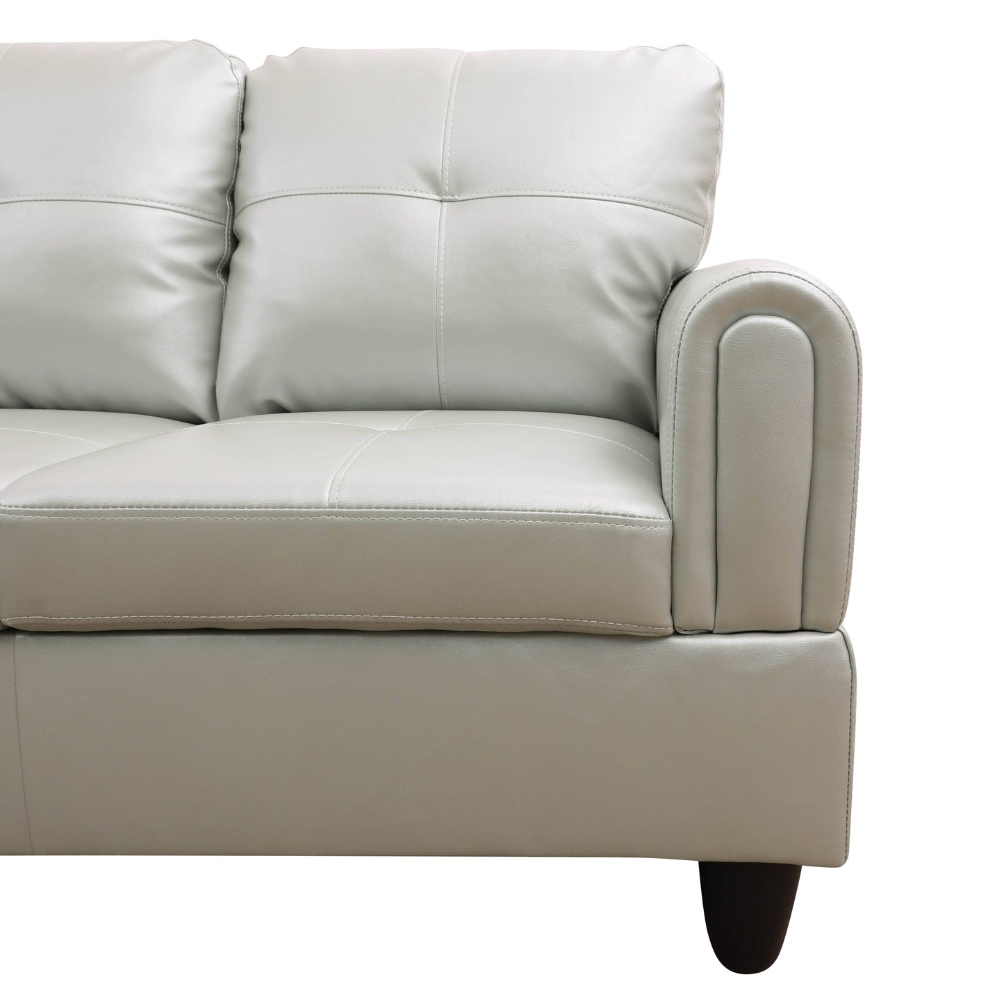 Closeup of a light gray leather sofa armrest with detailed stitching