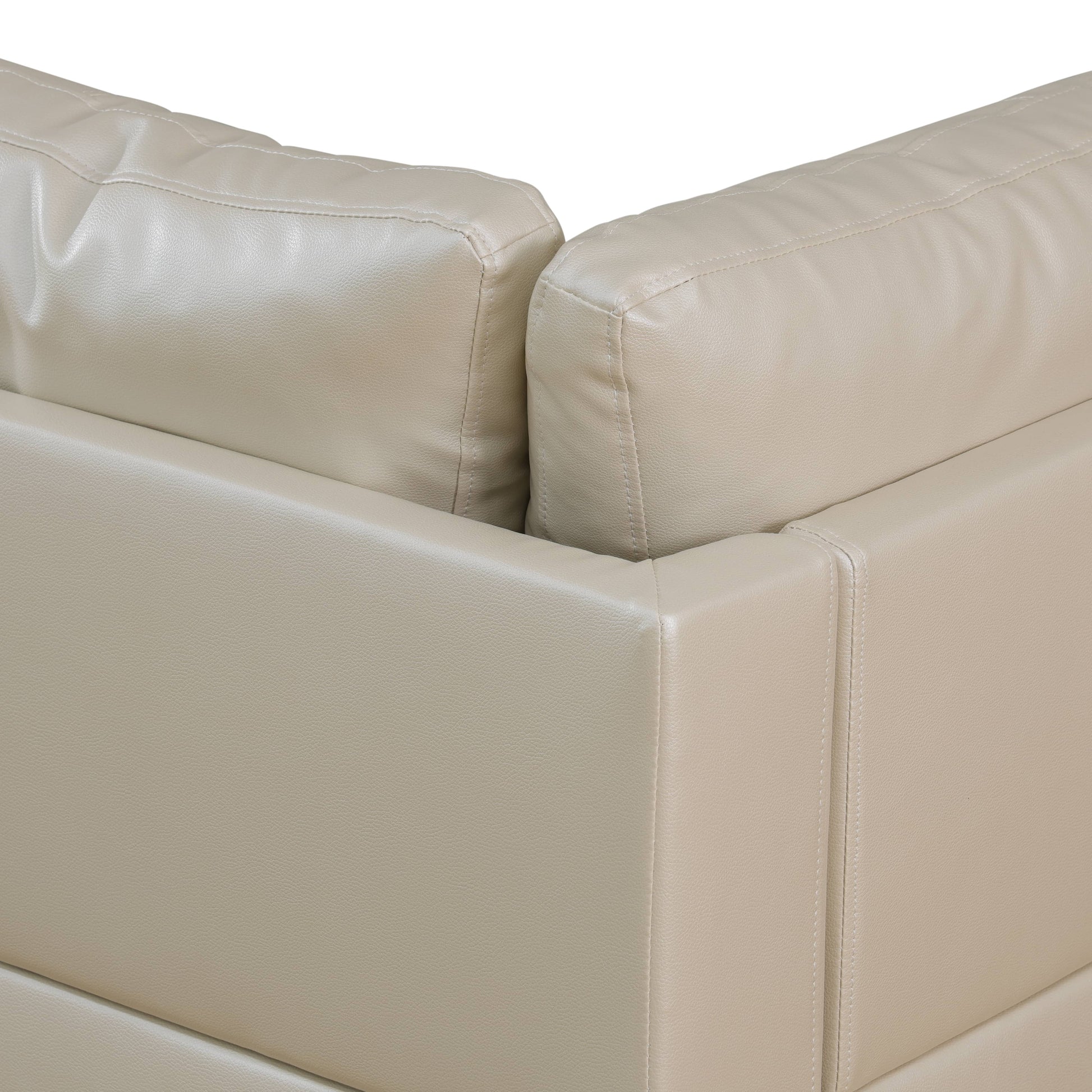 Closeup of beige faux leather sofa armrest with detailed stitching