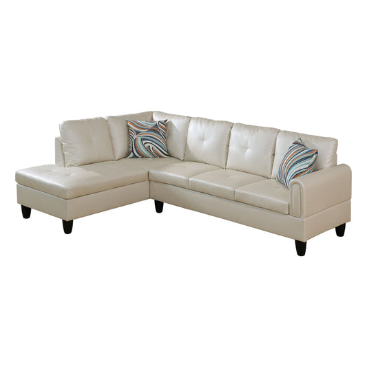 Cream faux leather sectional sofa with chaise and decorative pillows