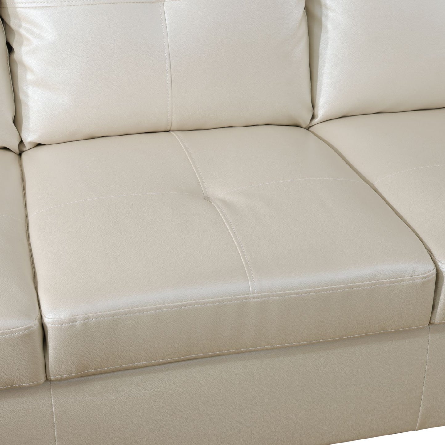 Cream leather sectional sofa cushions with detailed stitching