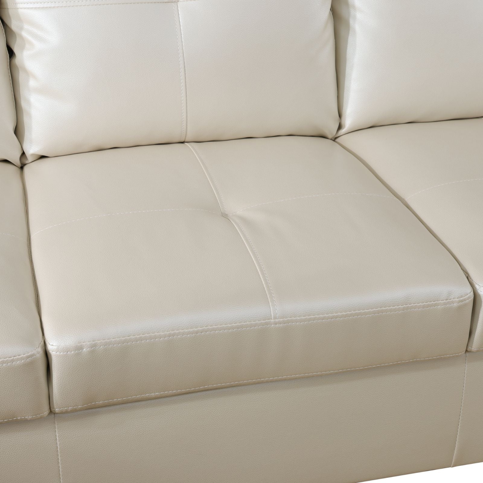 Cream leather sectional sofa cushions with detailed stitching