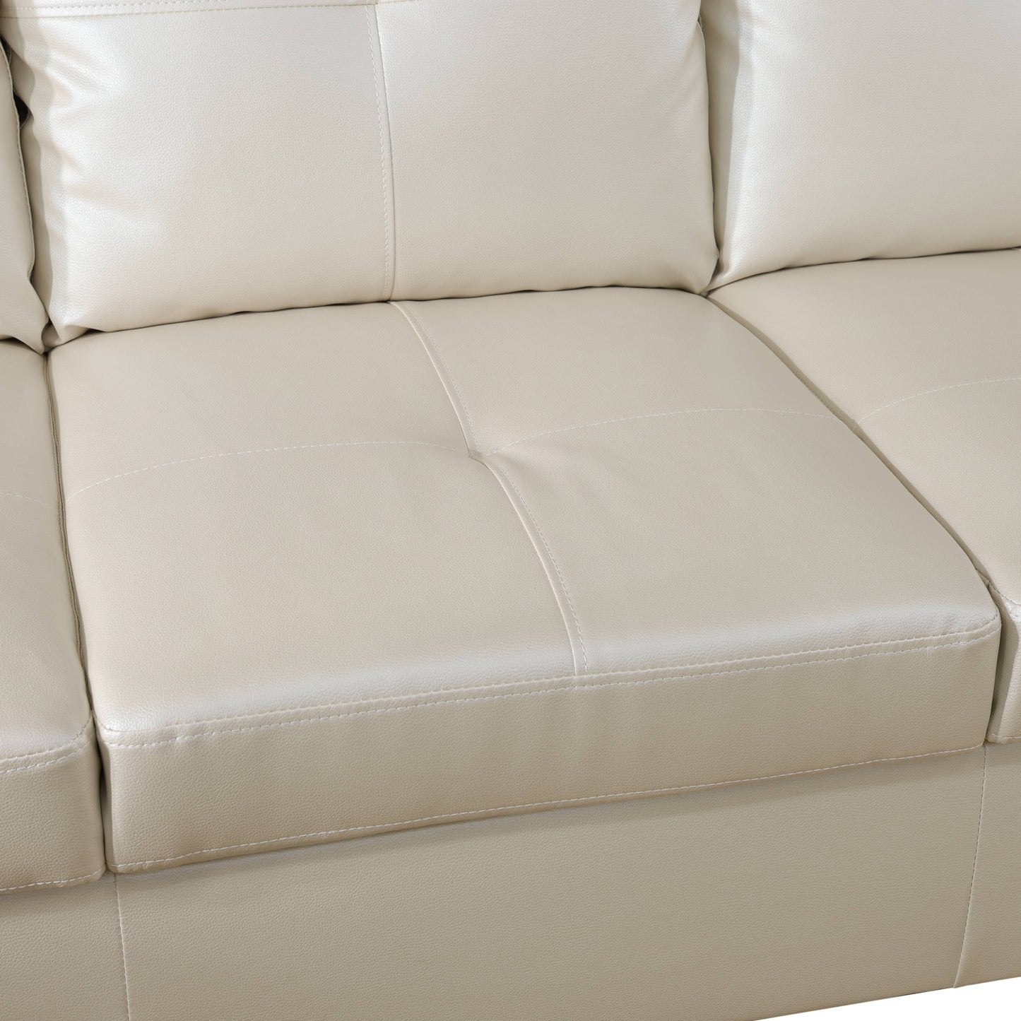 Closeup of cream leather sectional sofa cushions with stitched detailing