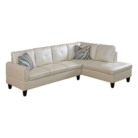 Cream faux leather sectional sofa with tufted cushions and decorative pillows