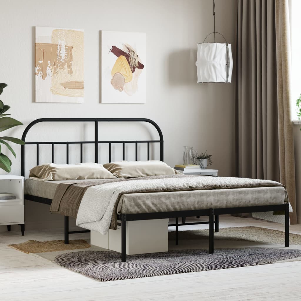 Arched black metal bed frame with twin XL mattress and patterned bedding
