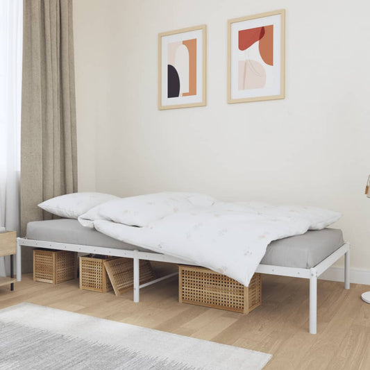 Silver metal twin bed frame with a white mattress and beige throw blanket