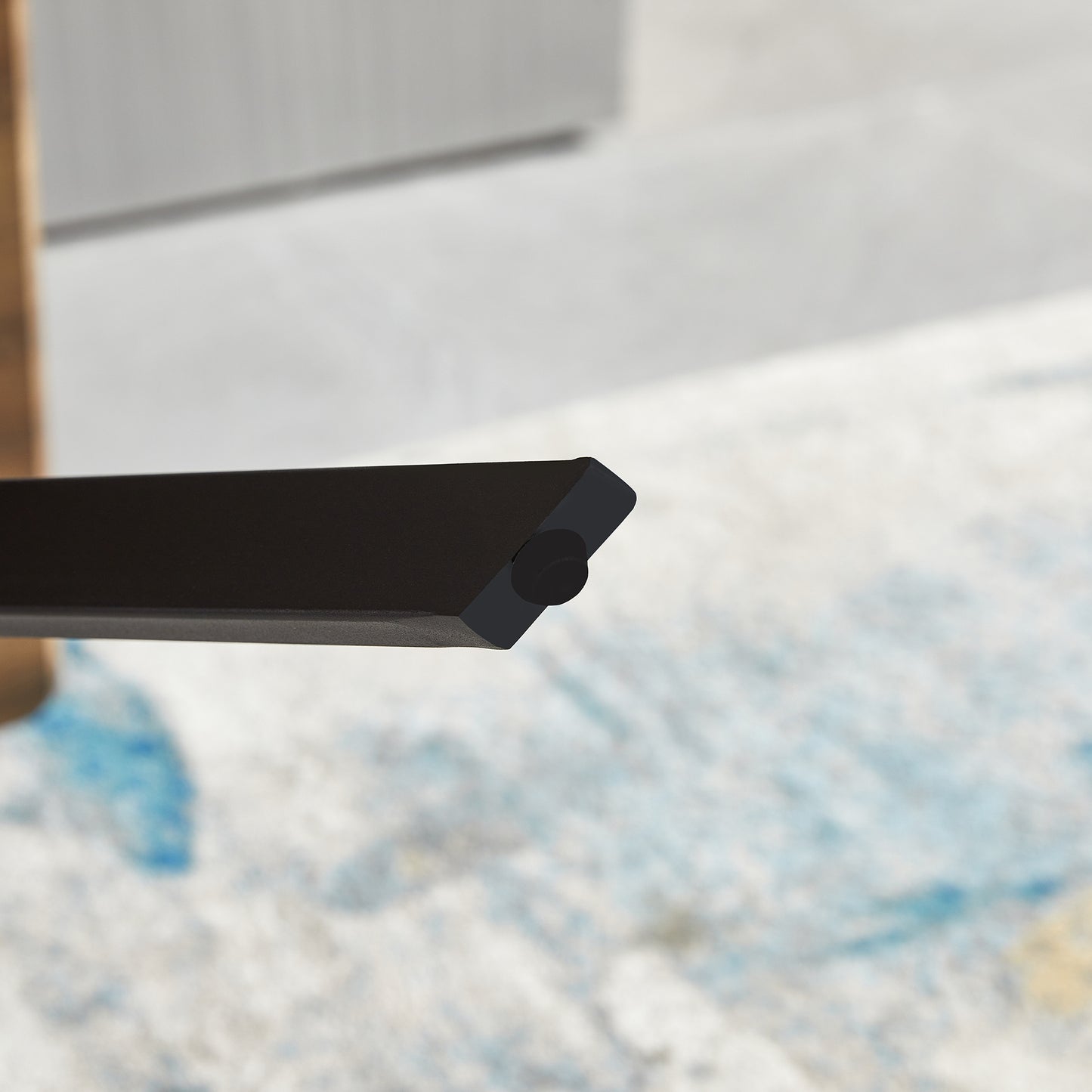 Black metal furniture leg detail with a floor protector