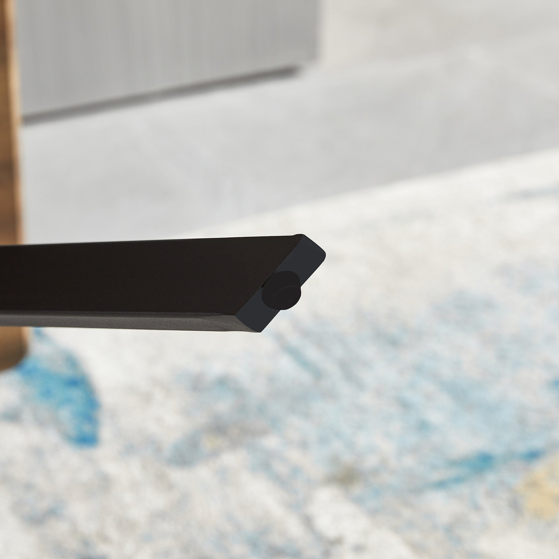 Black metal furniture leg detail with a floor protector