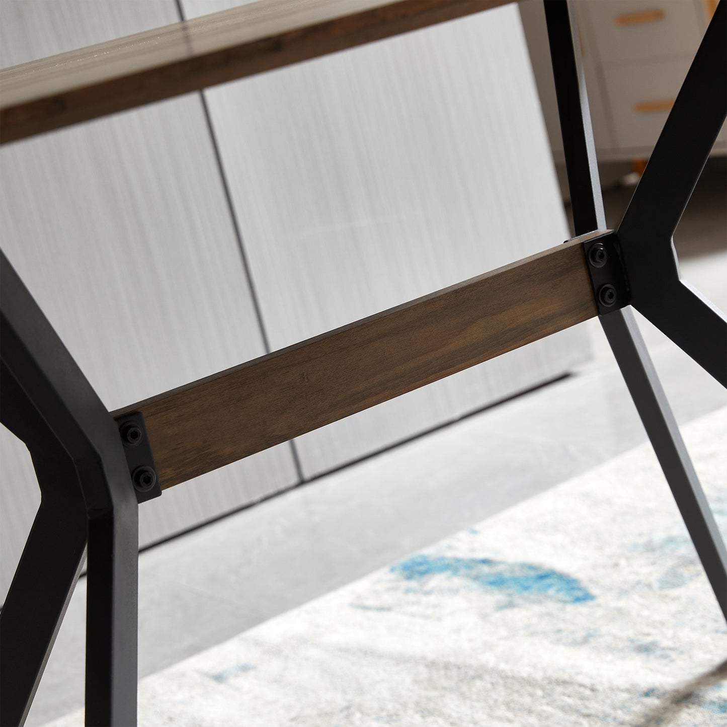 Closeup of dark wood beam with black metal supports
