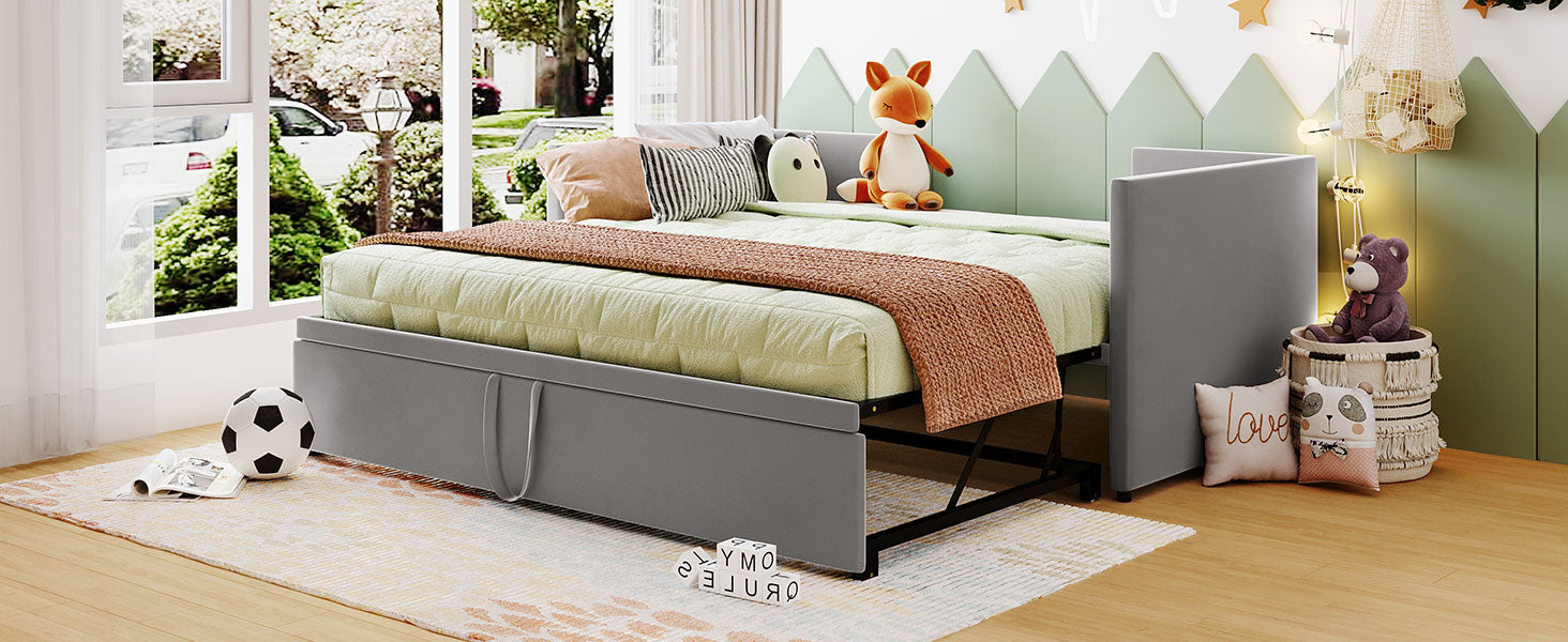 Gray toddler bed with pullout trundle and playful wall decor
