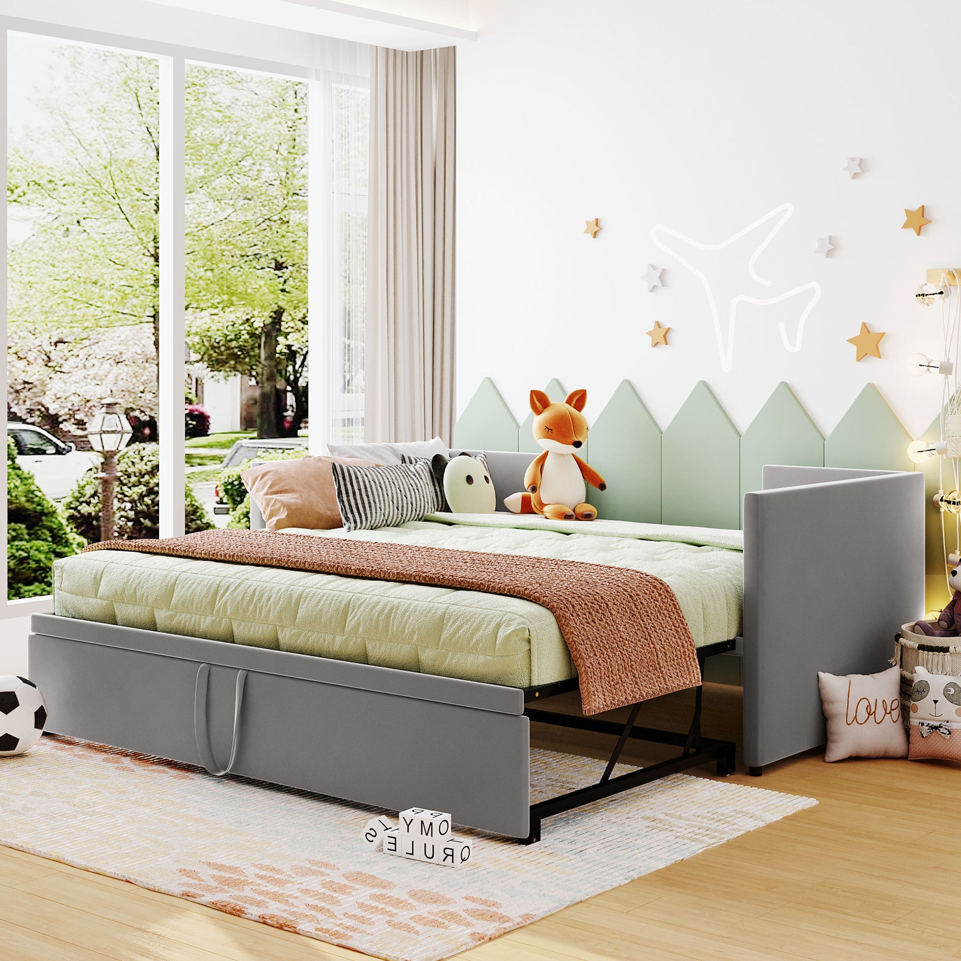 Gray fabric twin daybed with pullout trundle and quilted mattress