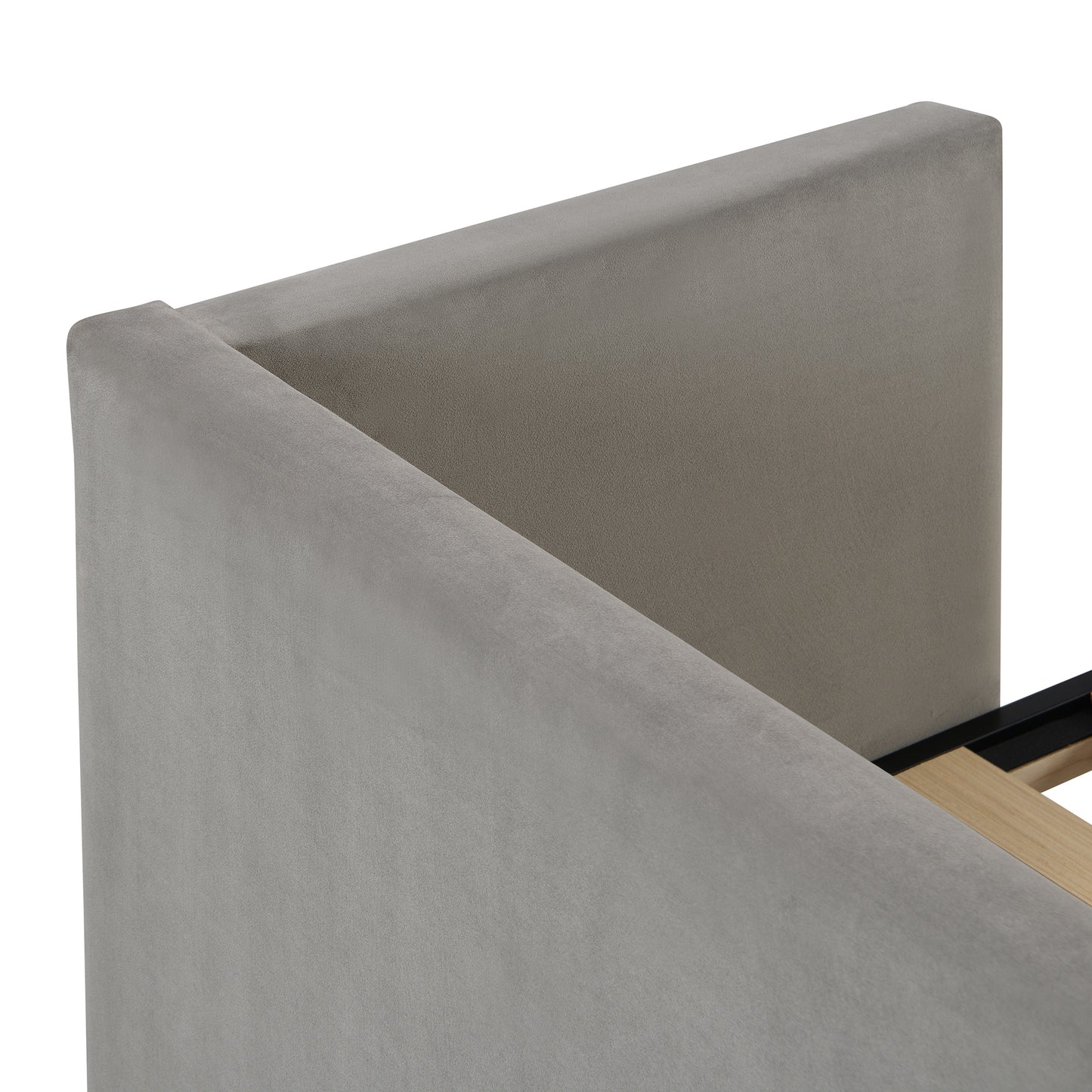 Closeup of a grey velvet upholstered headboard