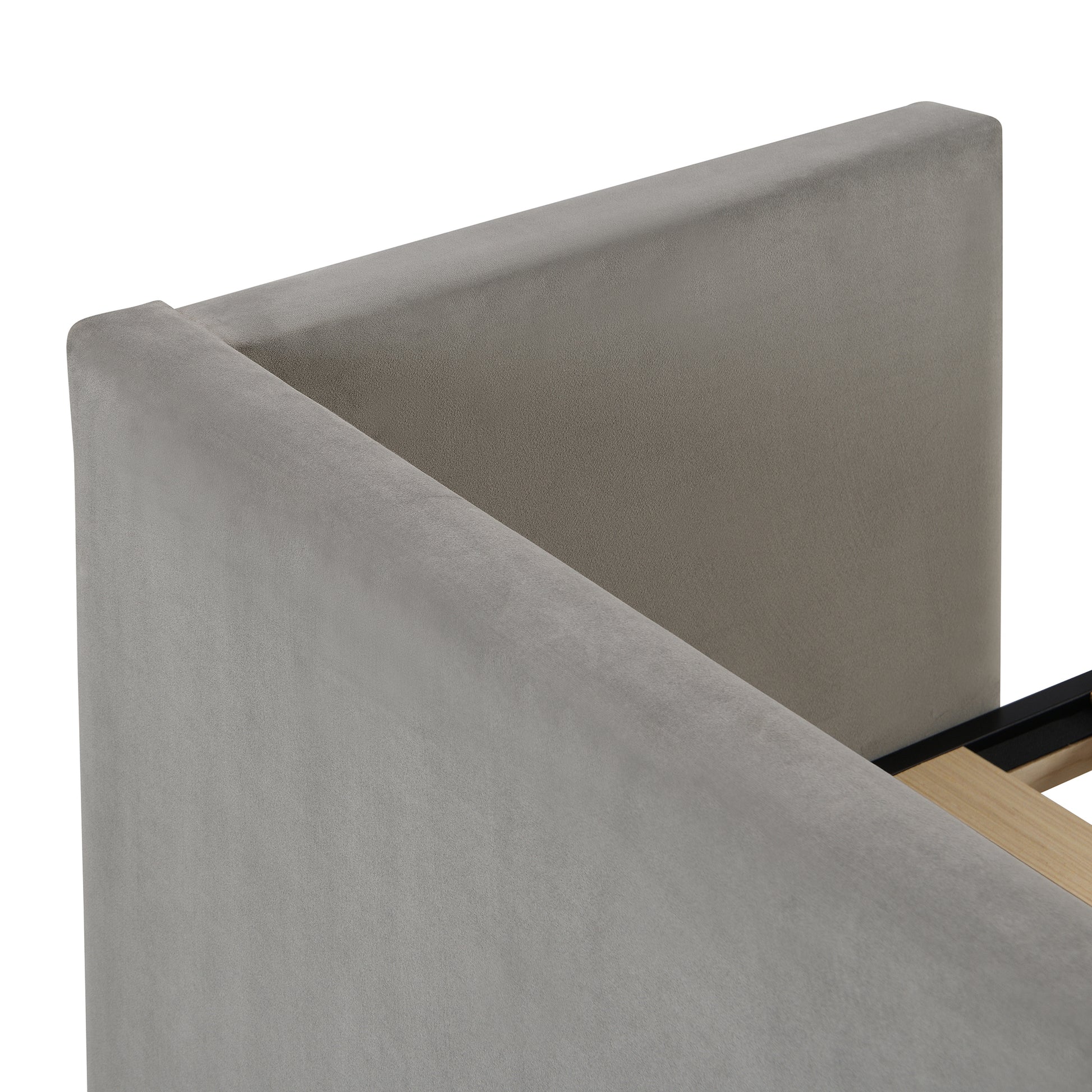 Closeup of a grey velvet upholstered headboard