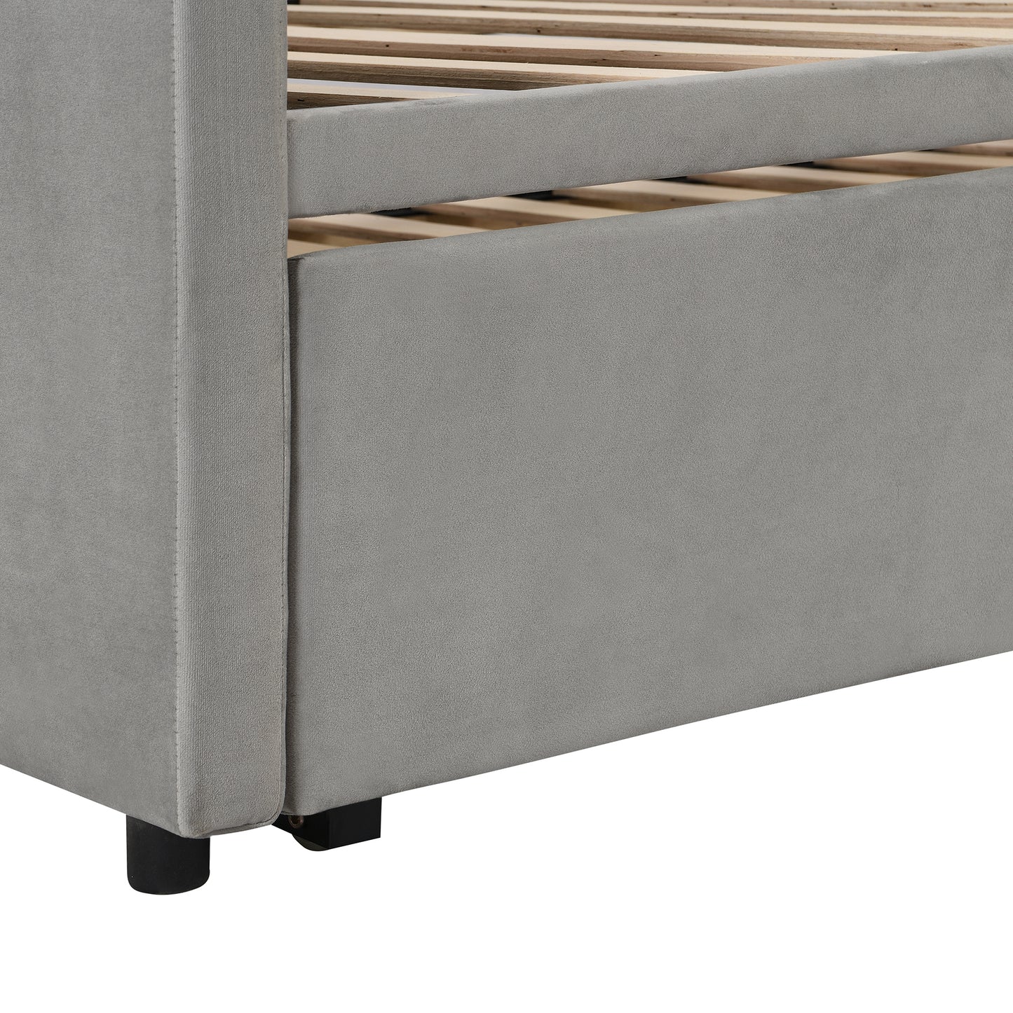 Gray velvet upholstered bed frame detail with wooden slats