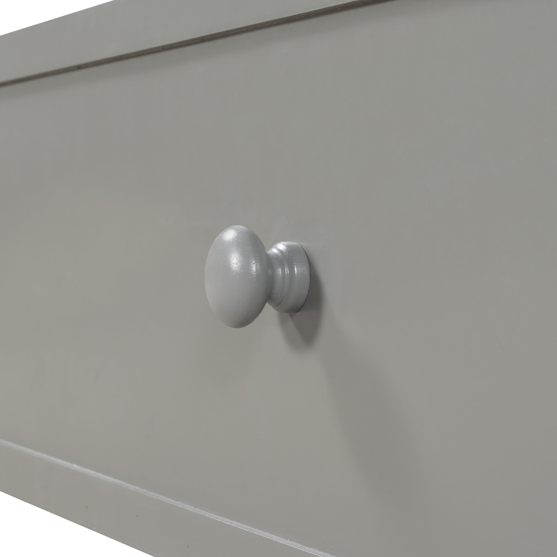 Gray wooden dresser drawer with round knob