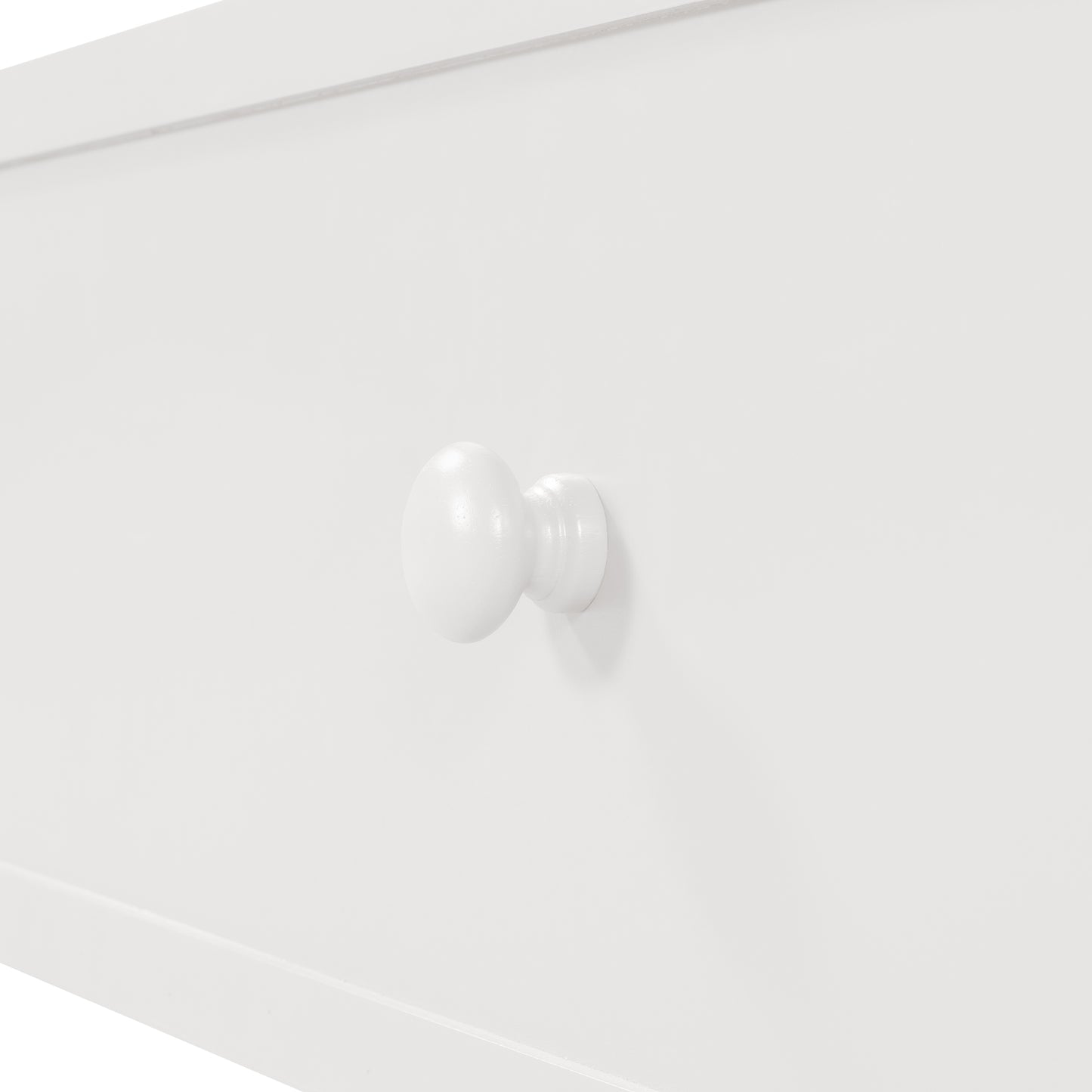 White wooden knob on a clean white drawer front perfect for childrens furniture